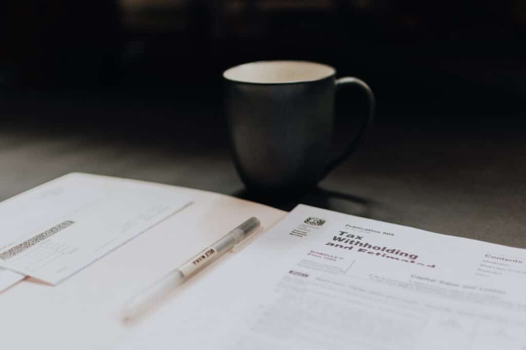 a tax document and a cup of coffee on the table for ways to partner with your accountant article