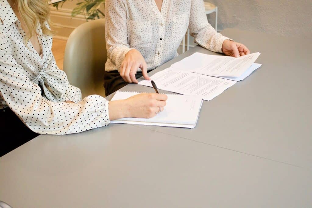 two women reviewing a set of documents