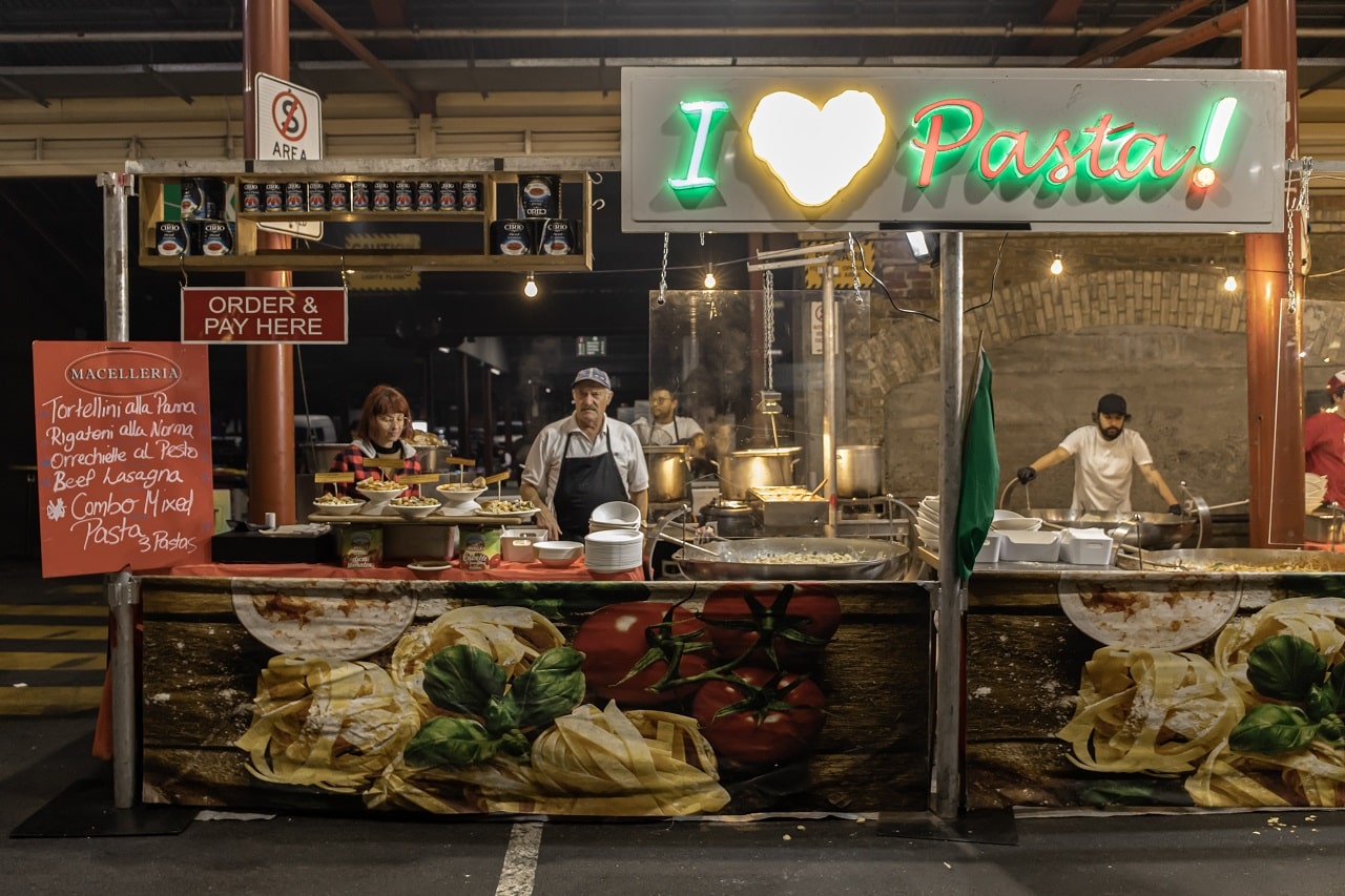 vendors wait for customers in the summer night market at the queen victoria market in melbourne, australia