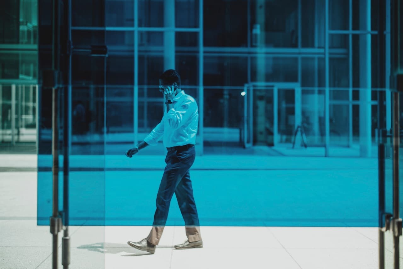 a business man walking while talking on the phone