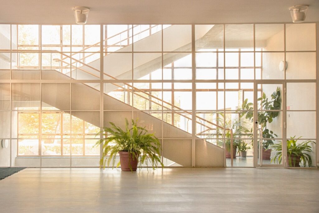a hospital pavilion with glass panels and plants