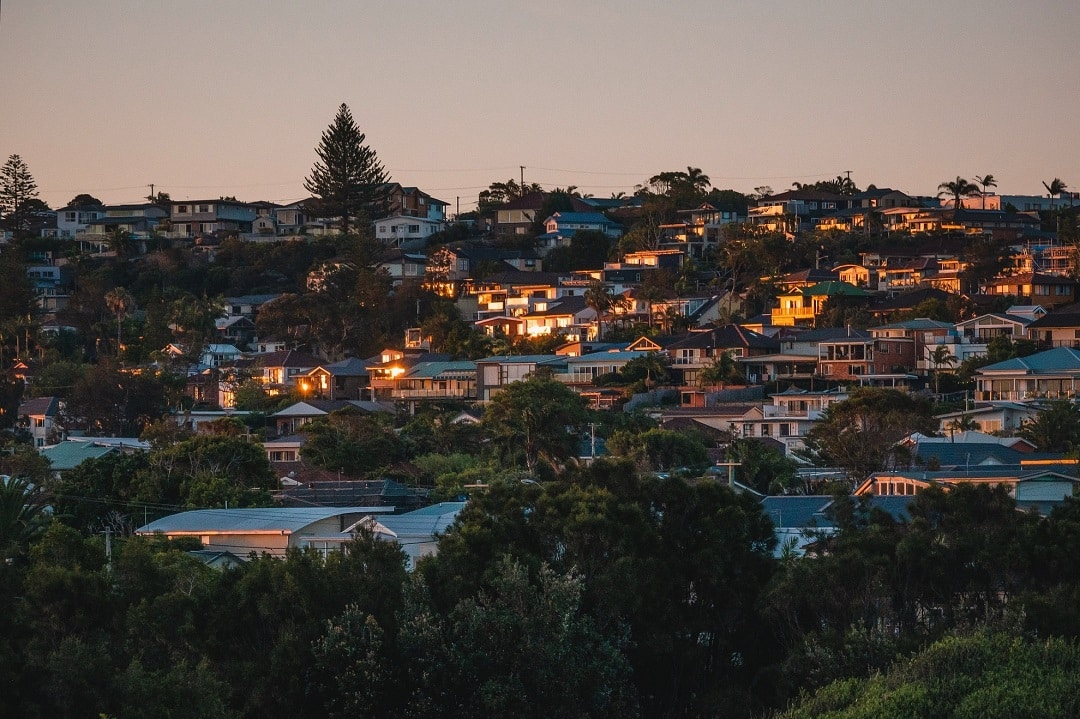 lights start to appear at dusk in a suburb in sydney, australia