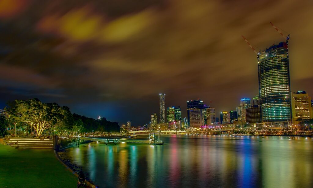building lights reflect on the brisbane river at night