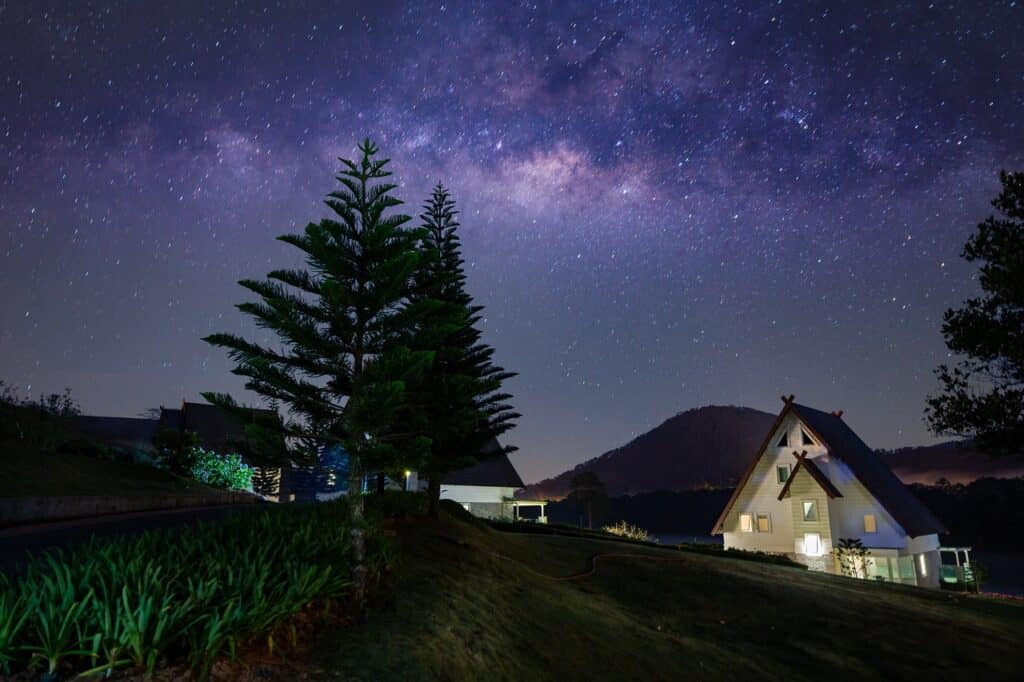 houses illuminated by a starry night