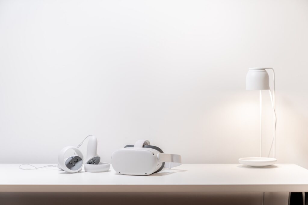 a white work desk with white gadgets and set against a white wall