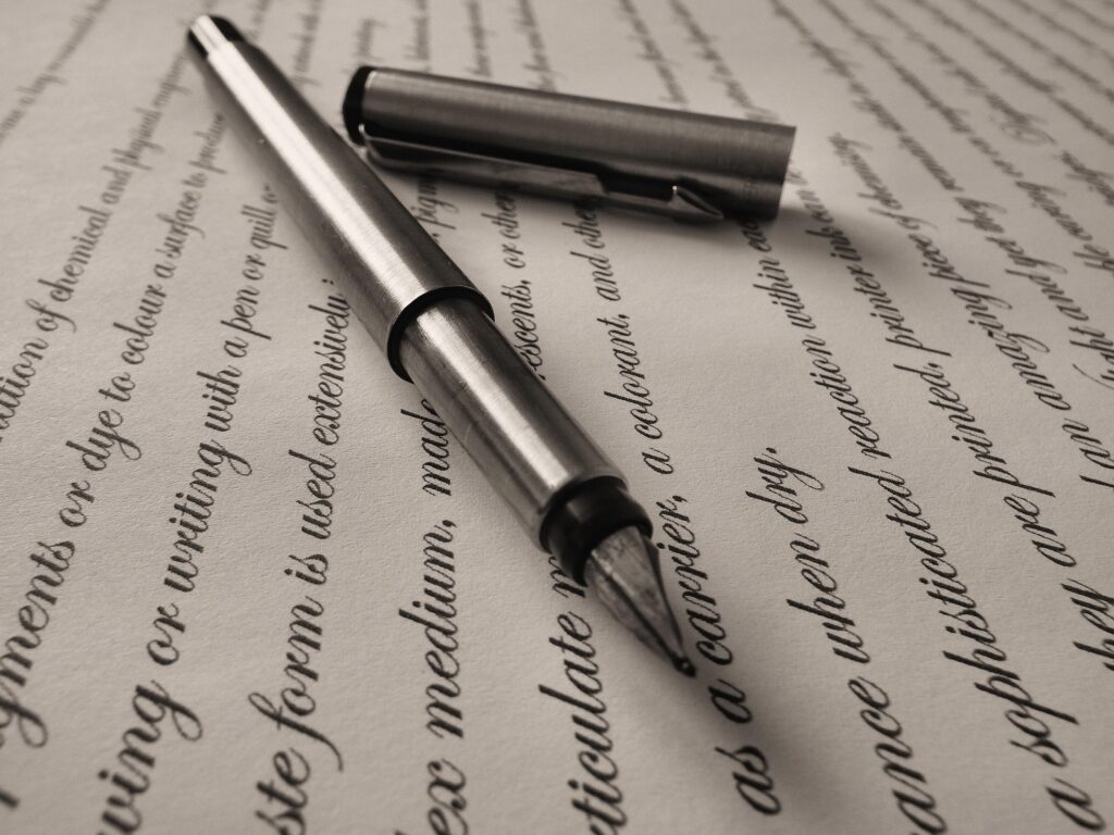 A close-up shot of a document with handwriting and a fountain pen