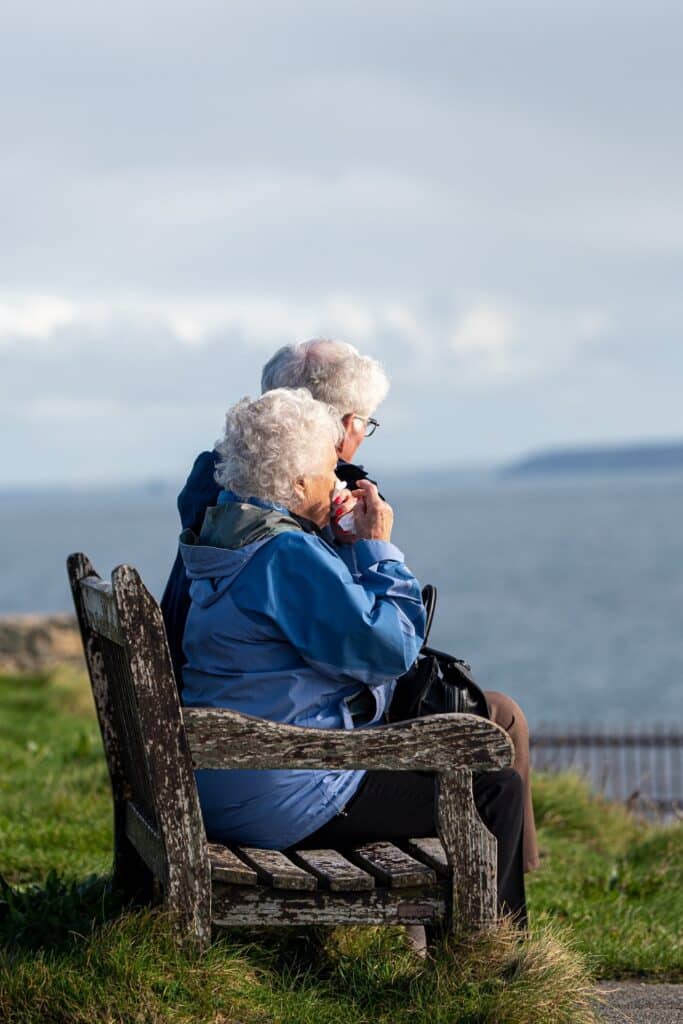 an old couple look out to sea in cornwall, uk
