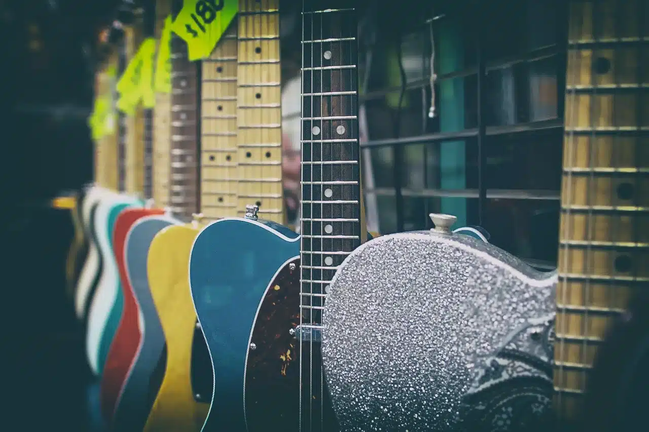 a line of guitars displayed inside a store