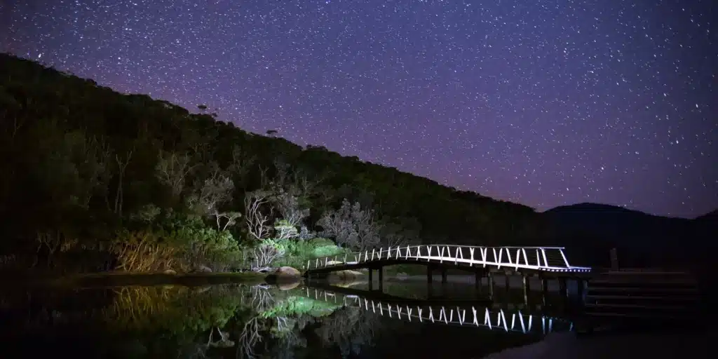 a nighttime view of the bridge at tidal river, west gippsland catchment, wilsons promontory, victoria, australia