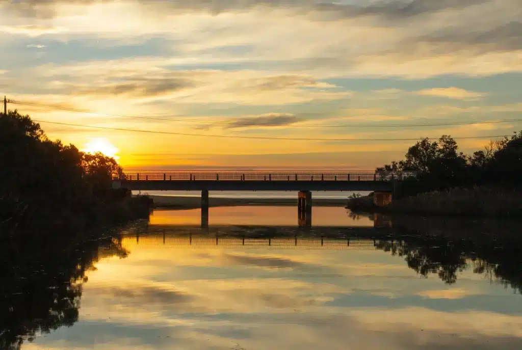 a sunset shot of the beach road bridge at balcombe creek, mt. martha, victoria, australia