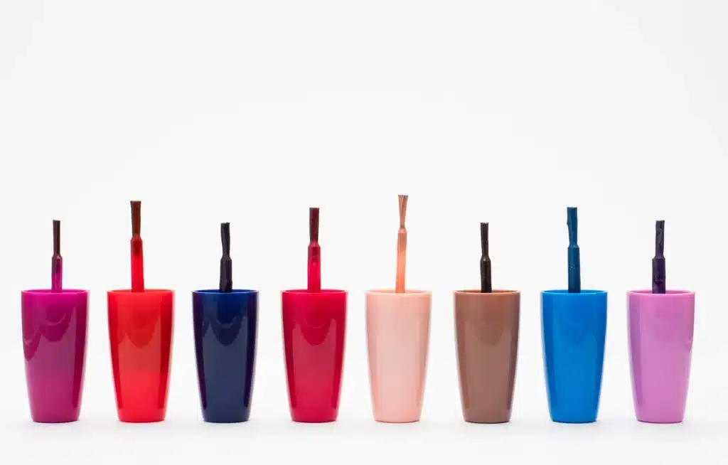 An image of a line of nail polish brushes representing the concept of tax deductions for beauty therapists.
