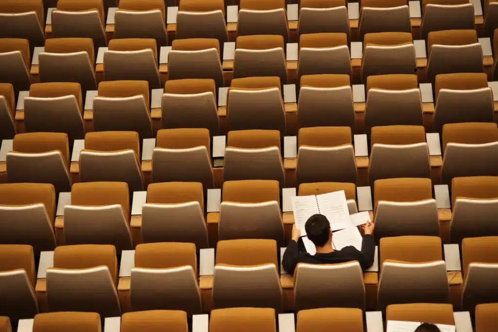 a lone student in a row of chairs representing the concept of tax deductions for teachers