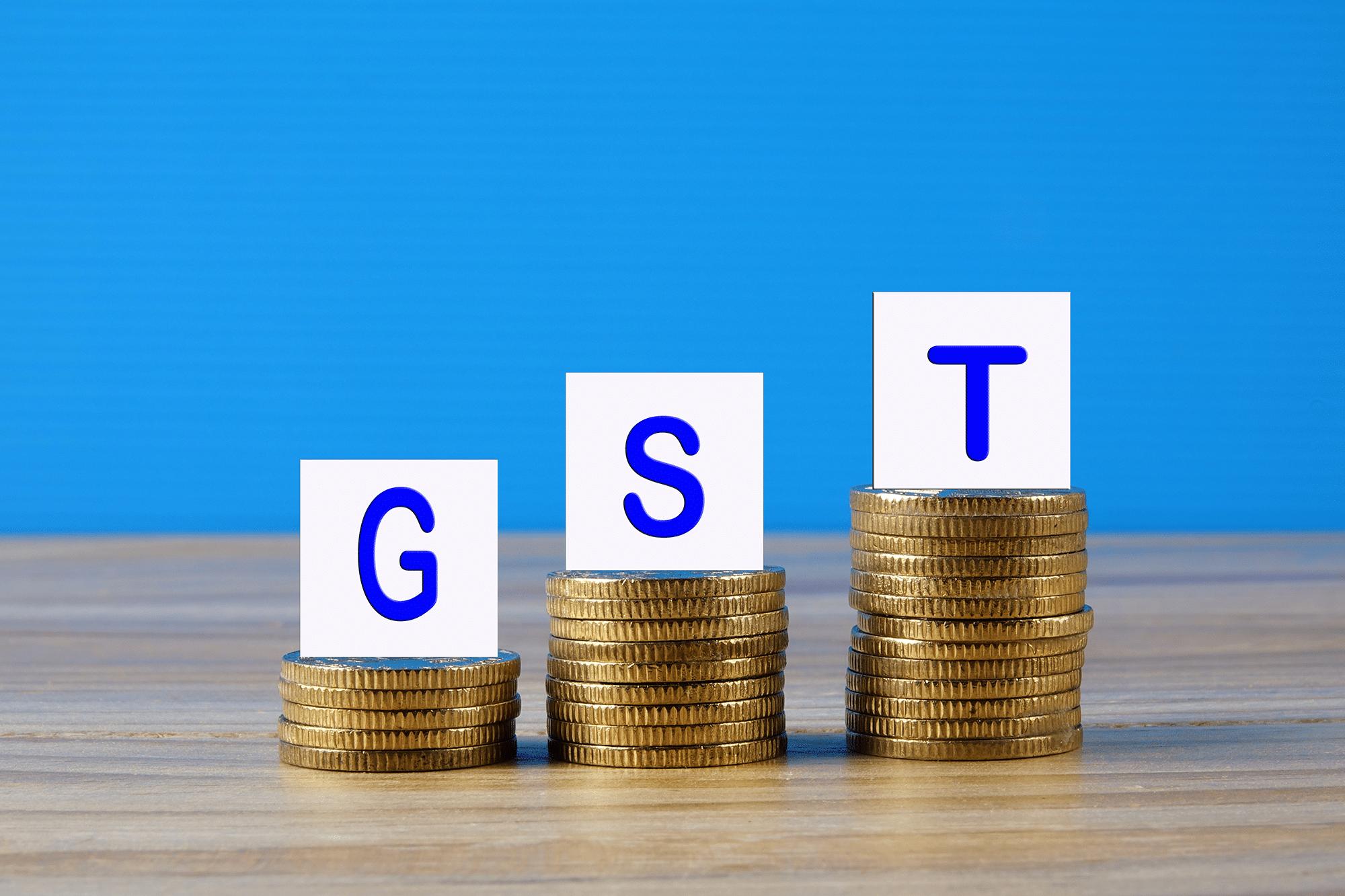 GST concept with stack of coins.