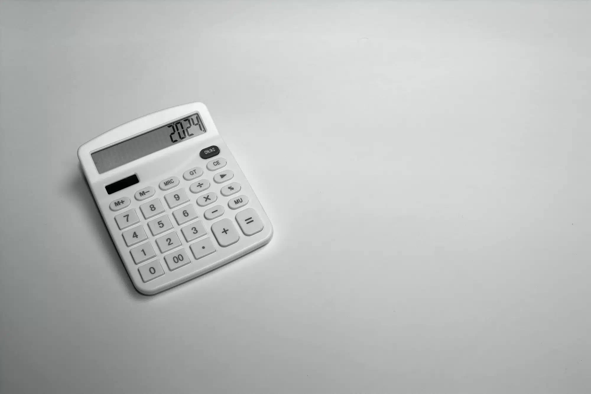 A white calculator on a white surface, representing the concept of GST accounting methods.