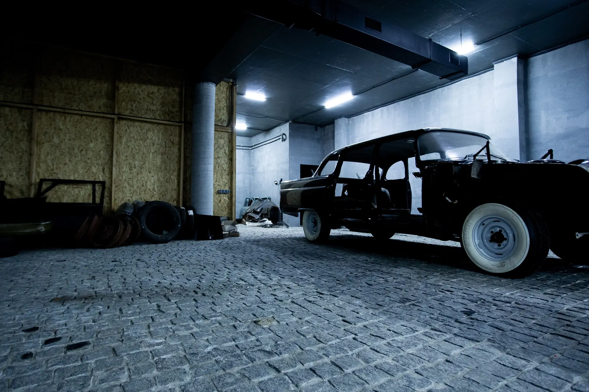 A black vintage pickup truck in the garage, representing the concept of GST and cars.