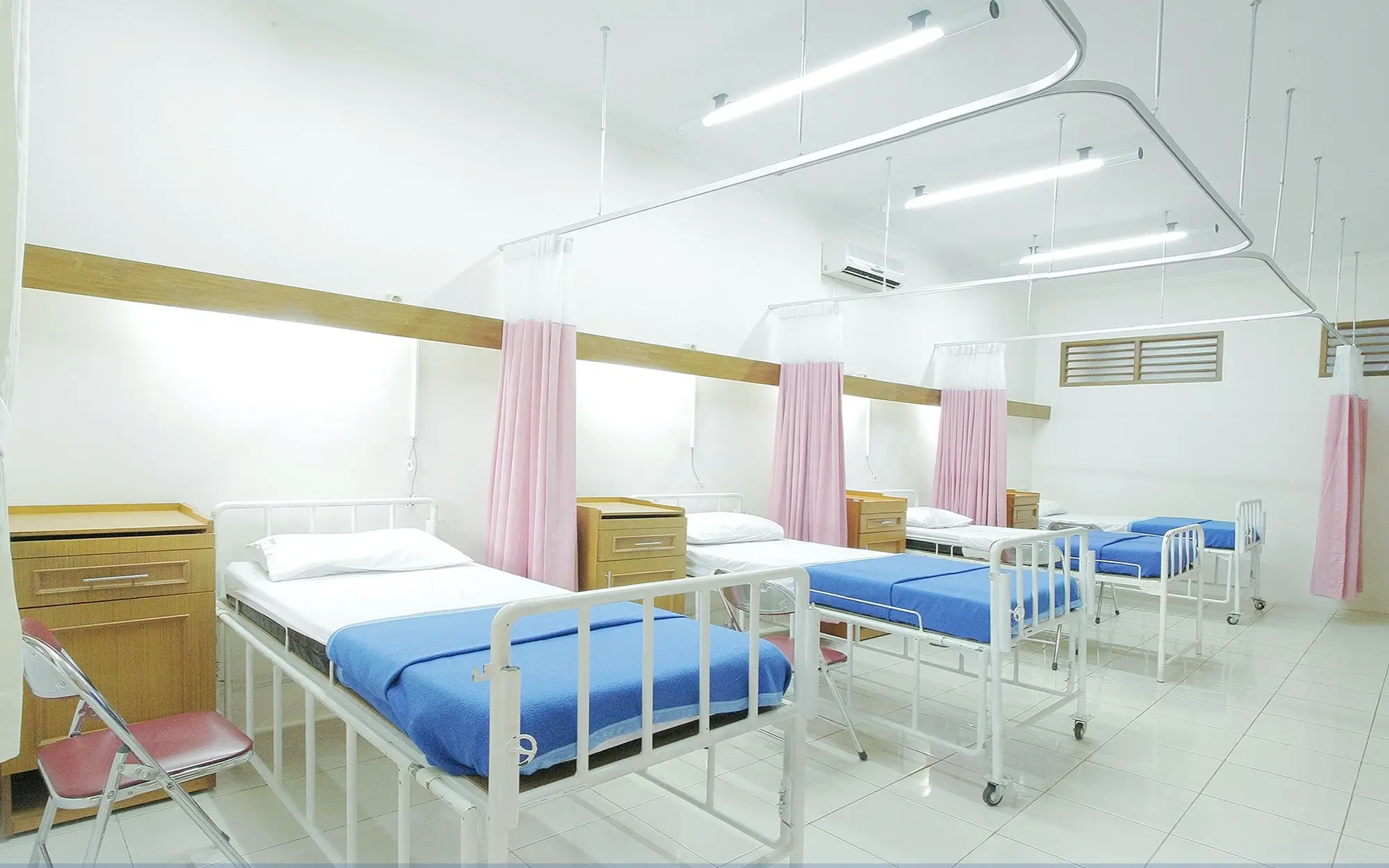 Empty beds inside a hospital, representing the concept of GST and health services.