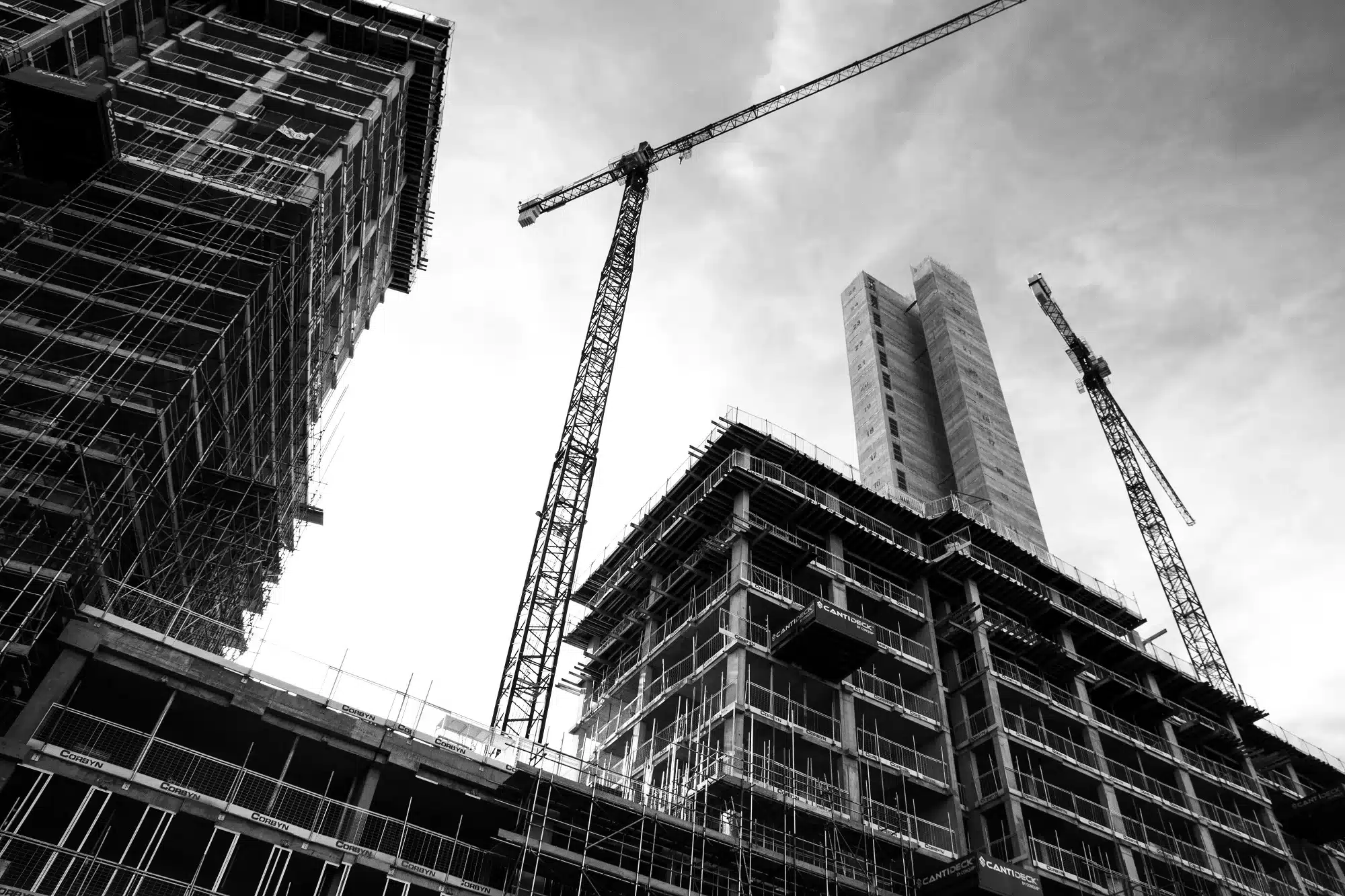 Grey scale photo of a building that is under construction, representing the concept of property development.