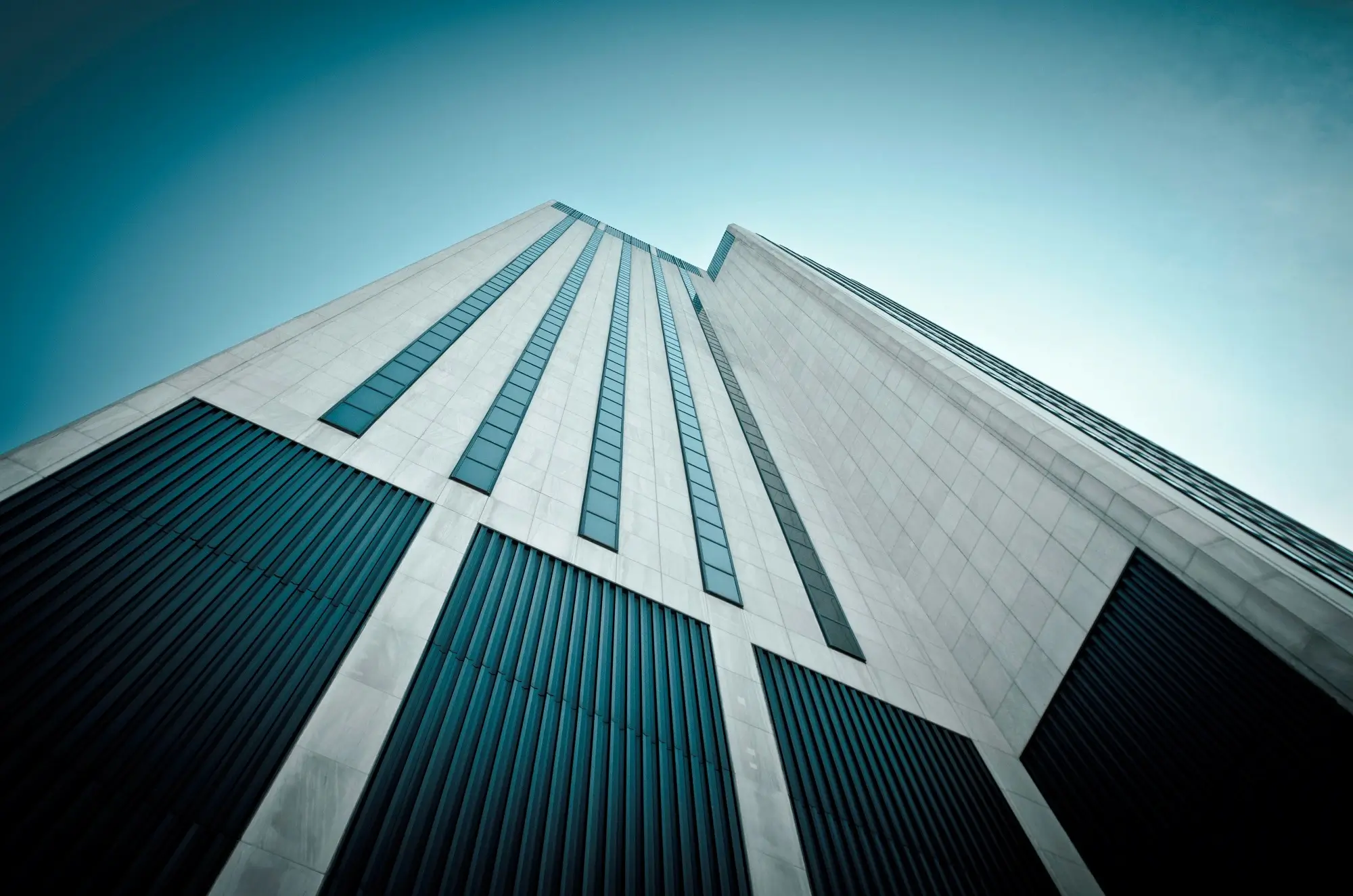 A worm's eye view of a black and white skyscraper, representing the concept of controlled foreign company.