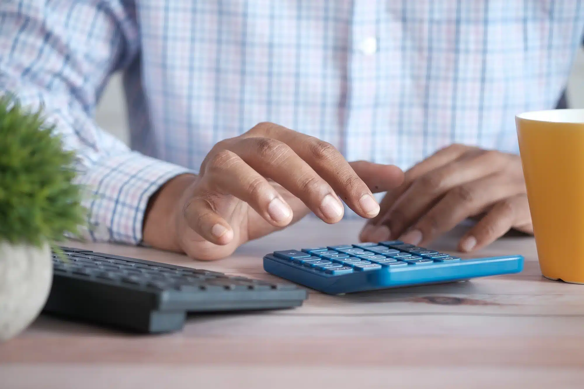 A man using a calculator representing the concept of FBT rebate.