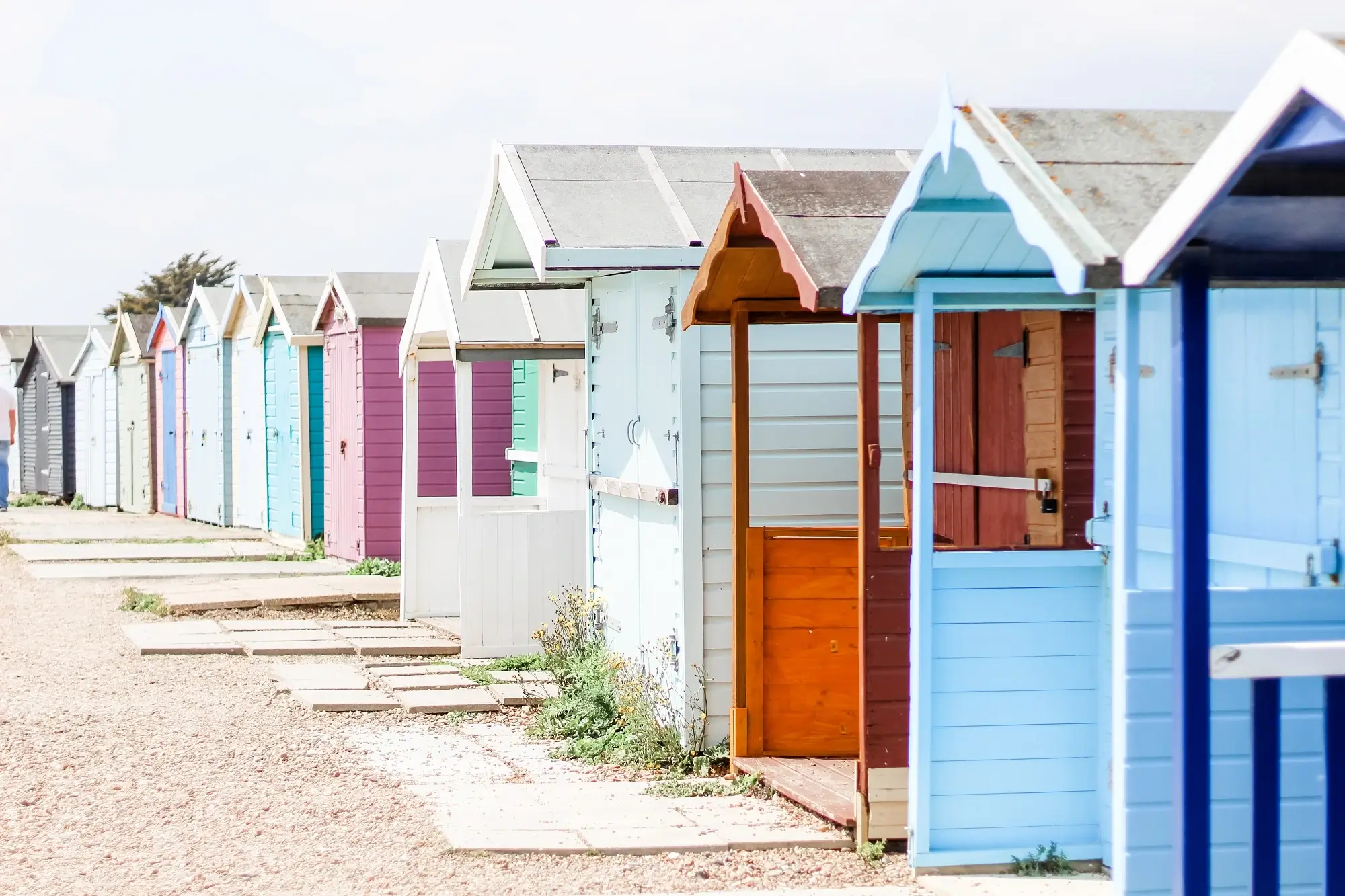 Beach huts painted in different colours in the English channel.