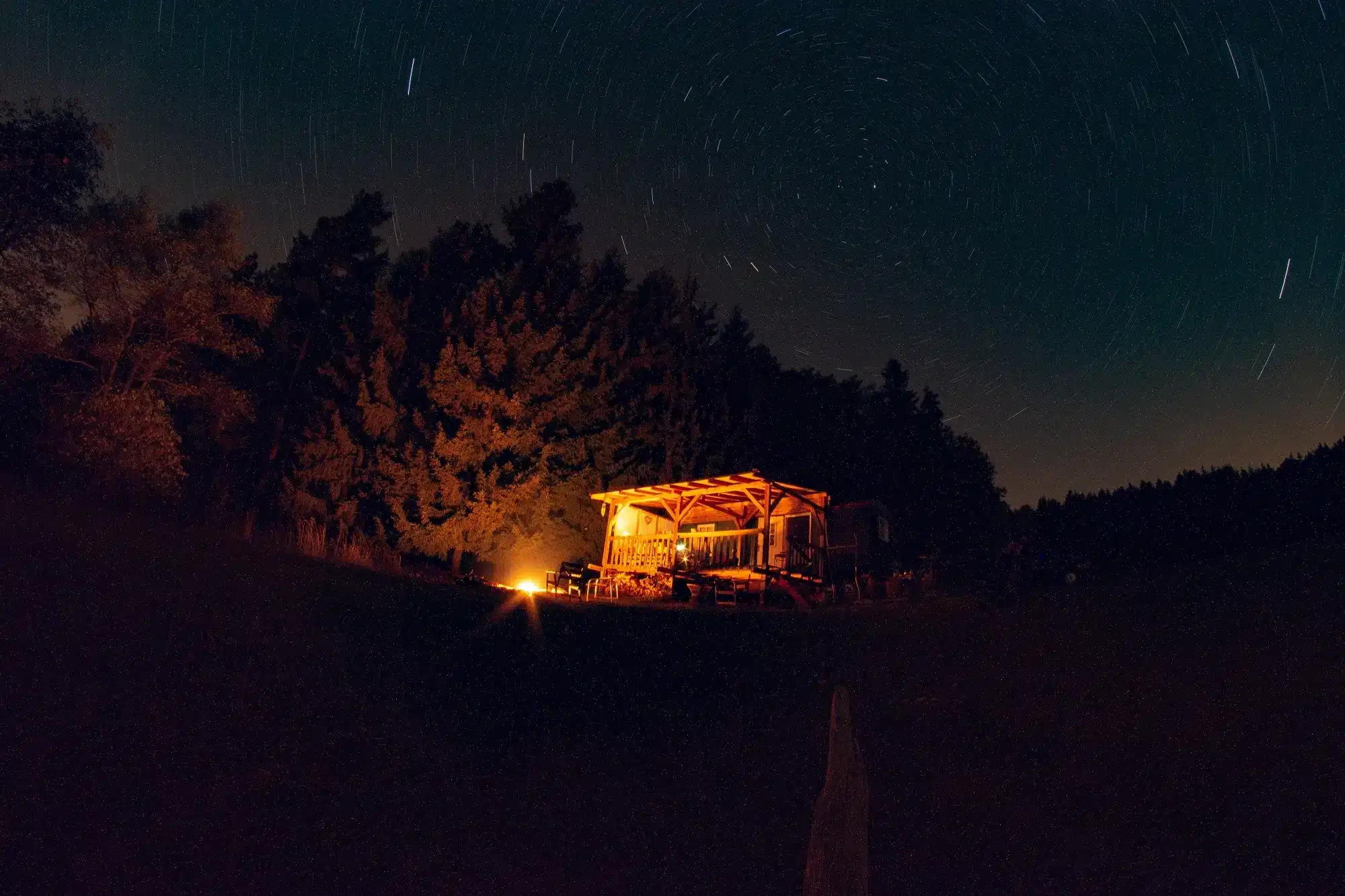 Night sky over the cabin somewhere in the forest.