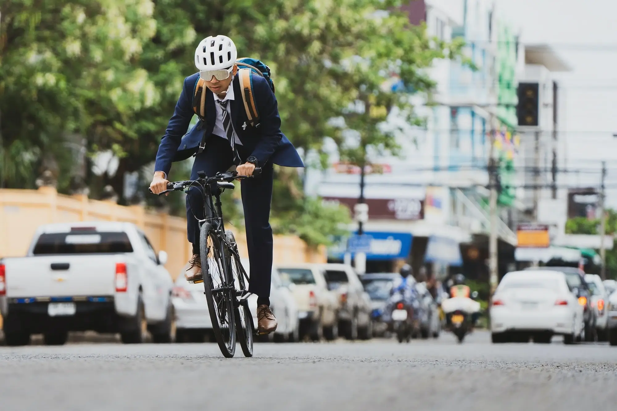 A man in suit cycling to work.