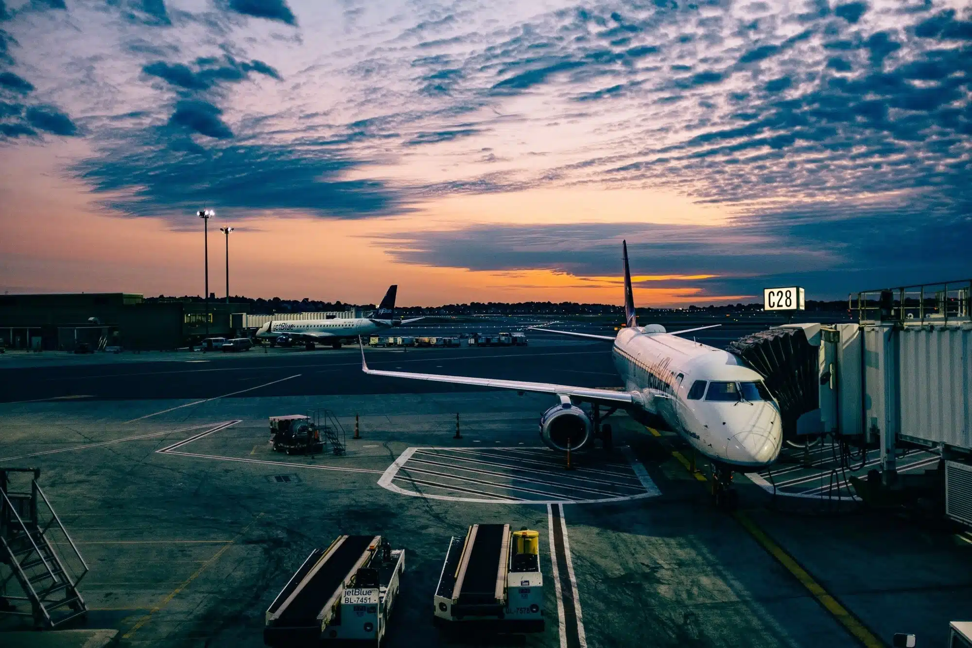 A plane unloading passengers in an airport, representing the concept of departing Australia superannuation payment.