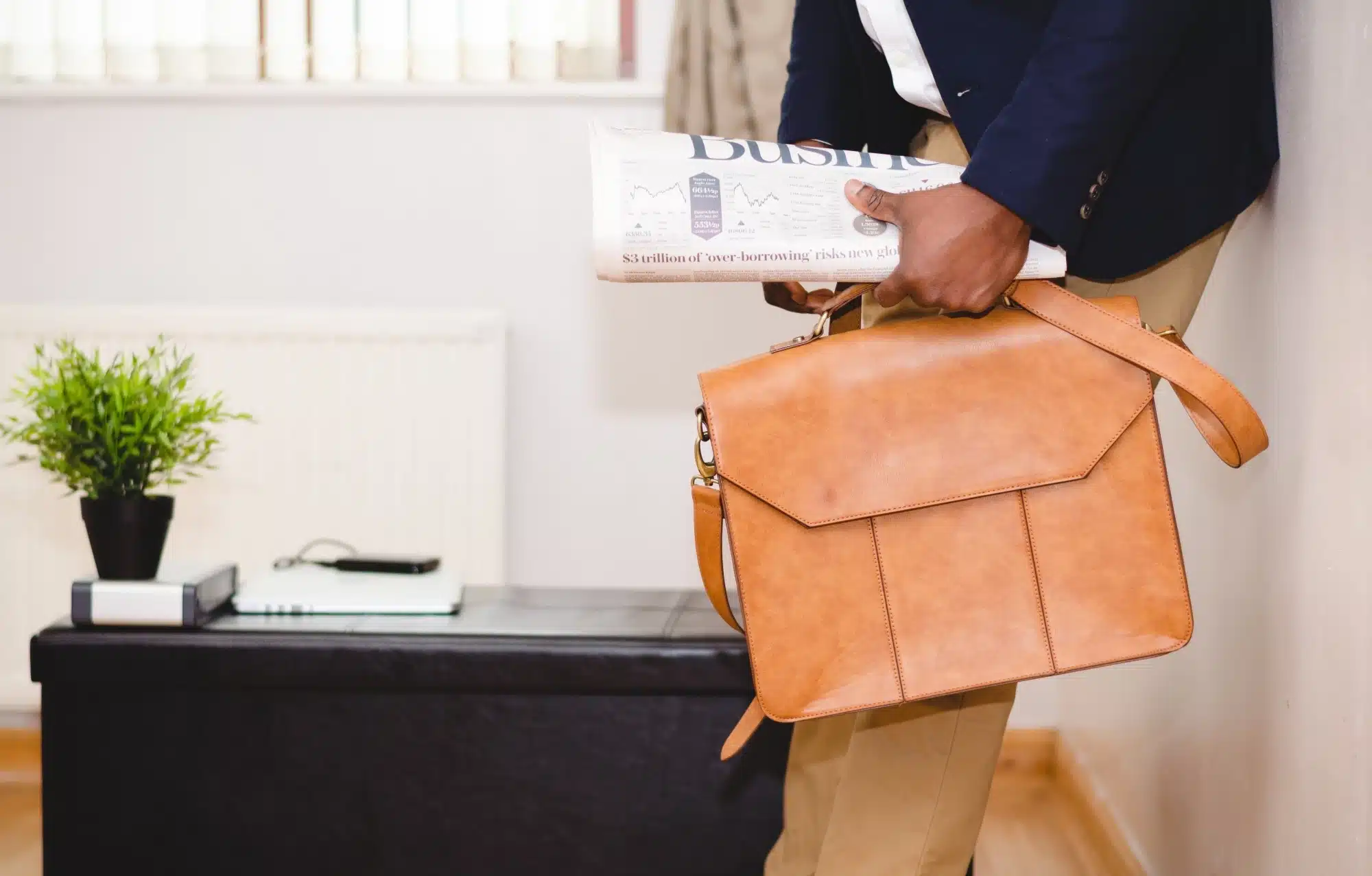dividend-withholding-tax-bristax-tax-accountants-2 A man in a suit and leather briefcase.