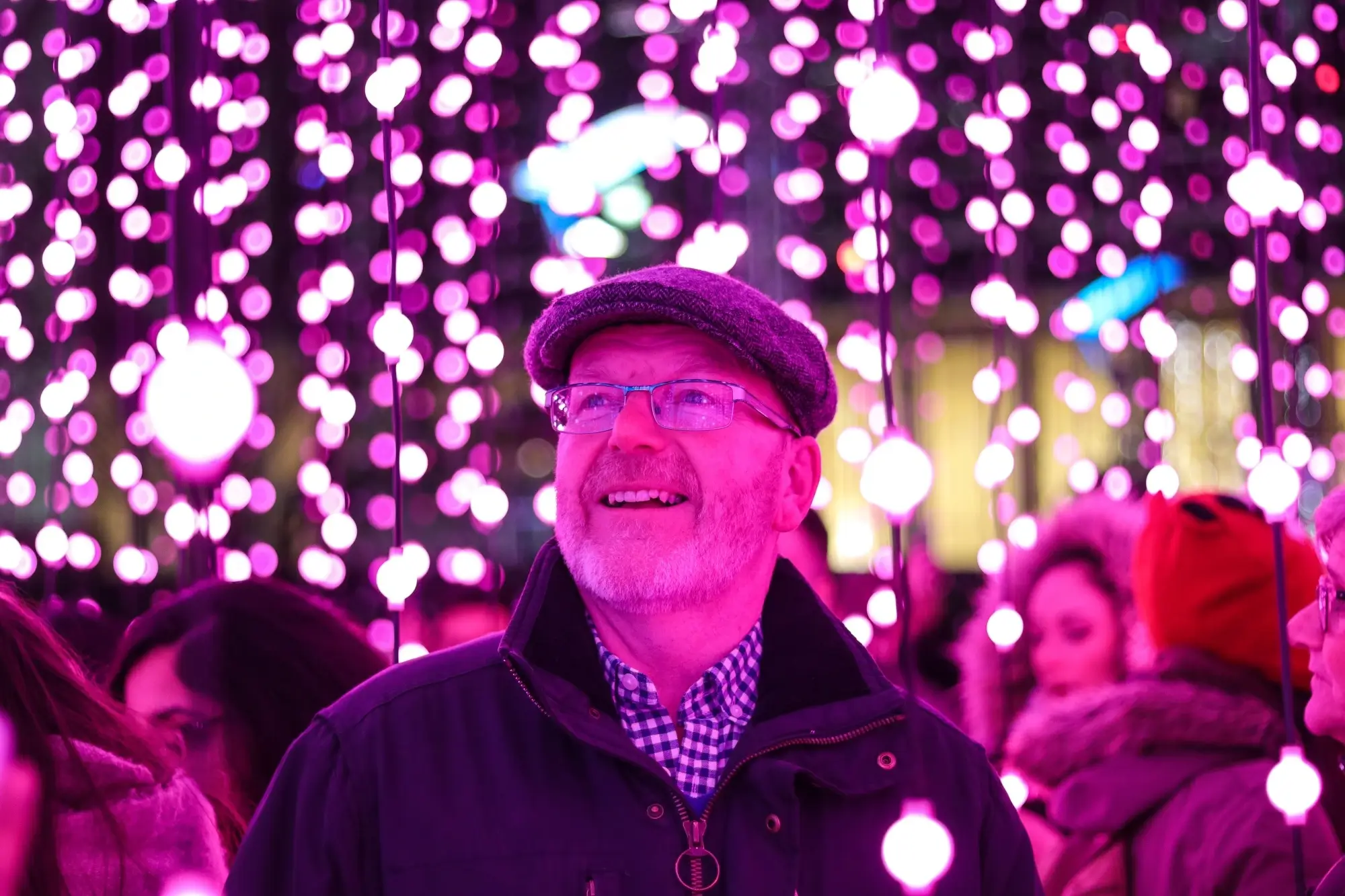 A retired man enjoying the lights on a festive evening, representing the concept of super contributions.