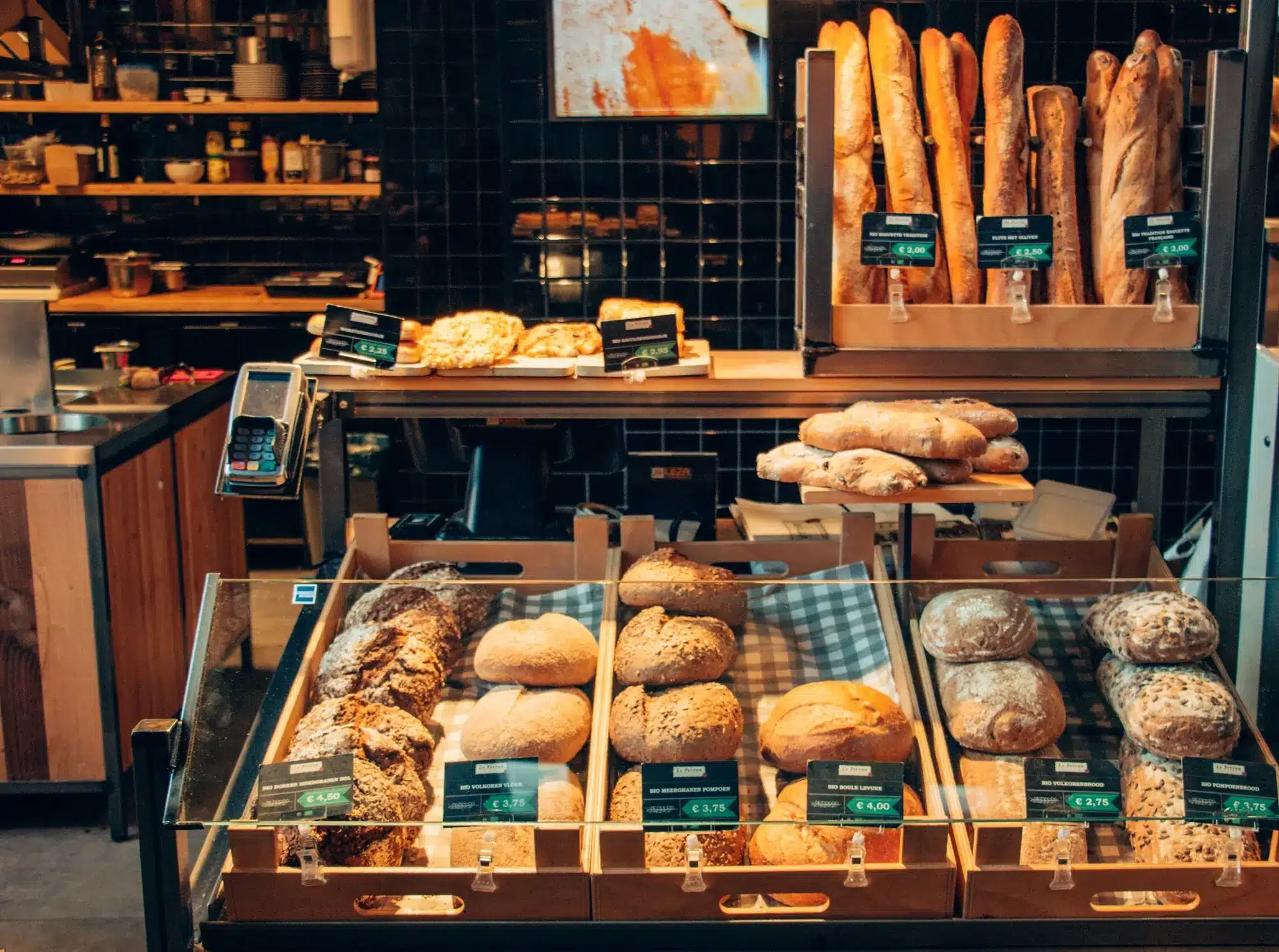 A display of pastries and bread inside a bakery.