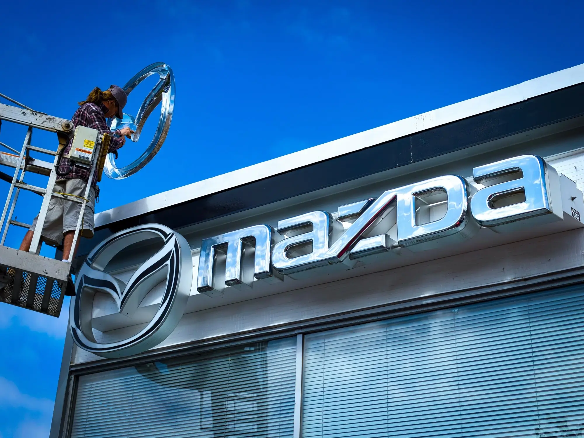 A closeup of a Mazda logo at headquarters.