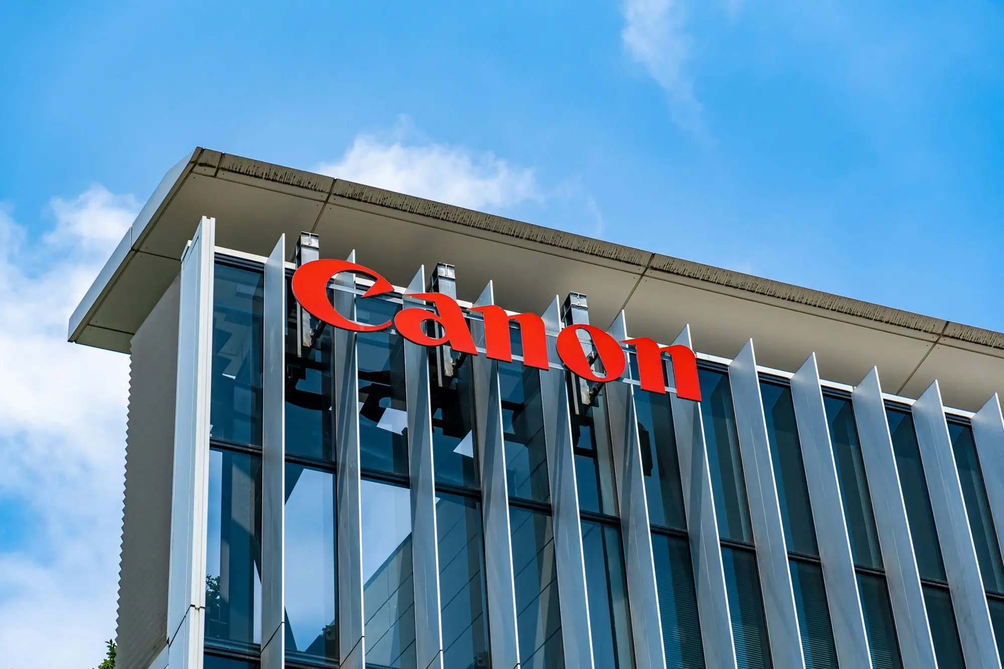 A closeup of a Canon logo at headquarters.