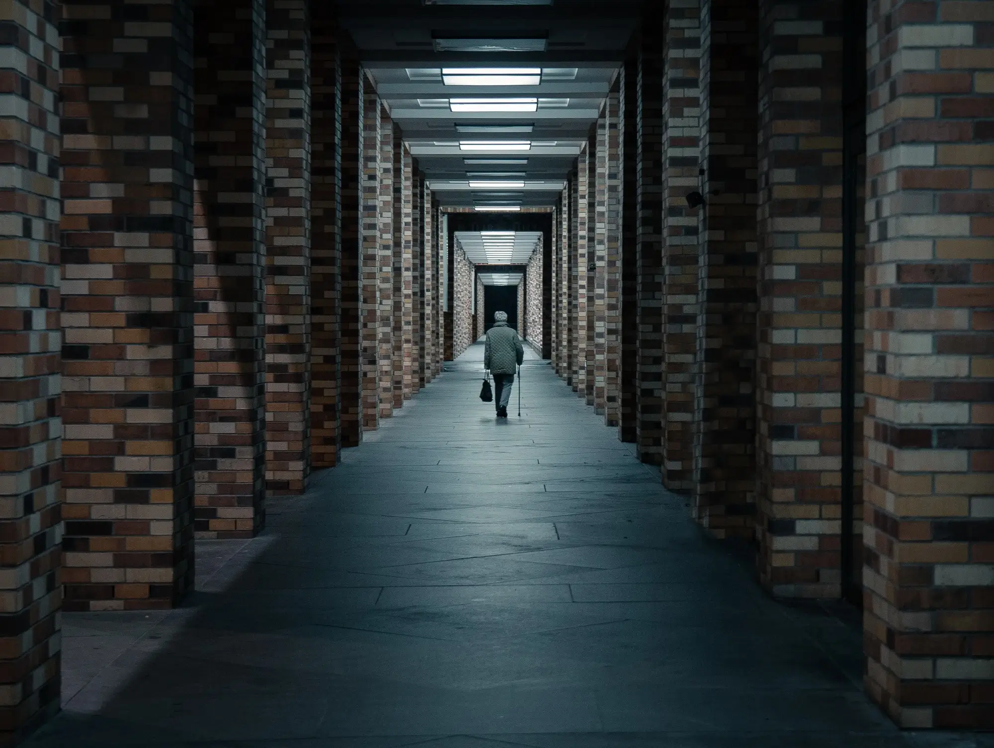 A man walking along an empty corridor, representing the concept of super death benefit.